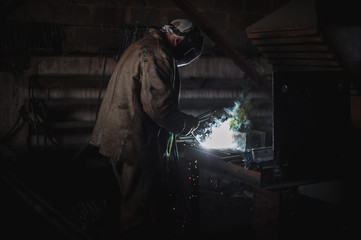 job of a welder. A large concrete products plant and welding on it.