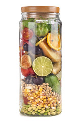 A jar of food with fruit, vegetables and grains. Food concept