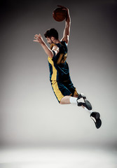 Fototapeta na wymiar Full length portrait of a basketball player with ball