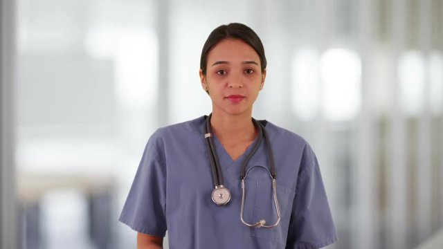 Young Mexican nurse standing in the hallway