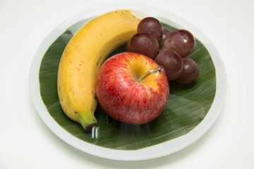 Fresh fruit in a plate on a white