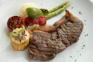  cooked rare sirloin steak  on a white plate