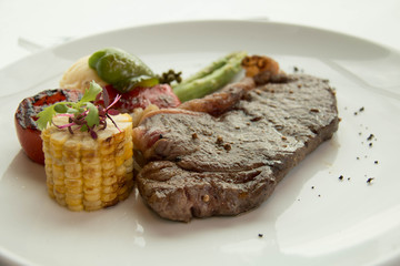  cooked rare sirloin steak  on a white plate