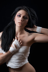Naklejka premium beautiful girl afraid of the ax on black background