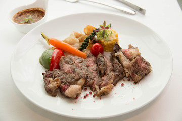 cooked rare sirloin steak  on a white plate