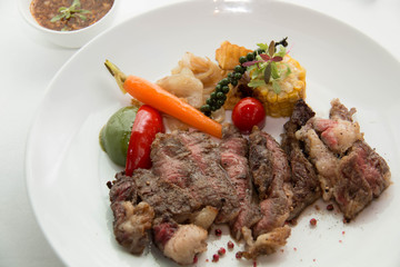  cooked rare sirloin steak  on a white plate