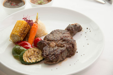  cooked rare sirloin steak  on a white plate