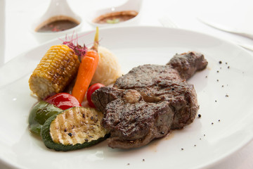  cooked rare sirloin steak  on a white plate