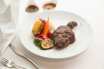  cooked rare sirloin steak  on a white plate