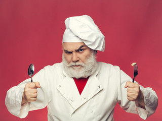 Bearded cook with spoon and fork