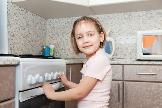 Child checking   stove at domestic kitchen