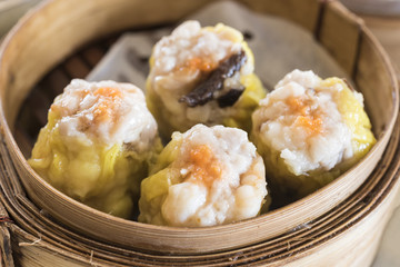 dim sum in bamboo steam containers - obrazy, fototapety, plakaty