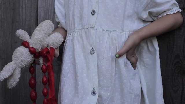 Little Business Girl Holding Toy Bunny With Scarlet Beads