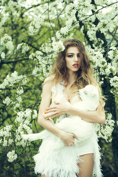 Woman with goat in blossom