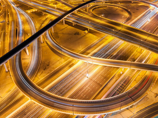 Obraz premium Extraordinary thoroughfare leading to Abu Dhabi during night rush hour near biggest skyscrapers. Traffic jam with multiple cars. Dubai, United Arab Emirates.