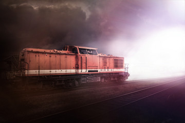 Güterzug fährt aus dem Dunkel ins Licht - obrazy, fototapety, plakaty