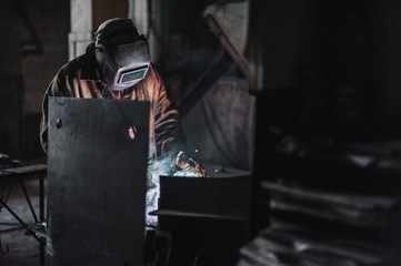 job of a welder. A large concrete products plant and welding on it.