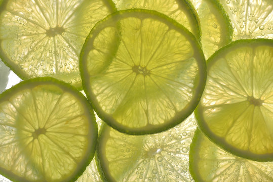 Lime slices in water with bubbles