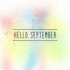 Hello September text on pastel spray paint background