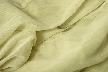 A full page close up of soft pastel yellow chiffon fabric texture