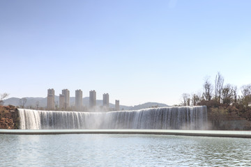 Kunming, China - March 4, 2016: Kunming Waterfall park featuring a 400 meter wide manmade...