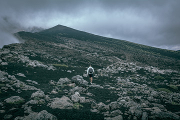 Man walking in the mountain in a foggy day