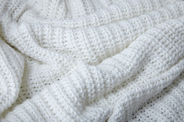 A full page close up of cream knitted fabric texture