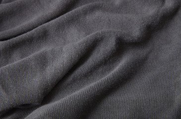 A full page close up of ripples of grey fine knit fabric texture