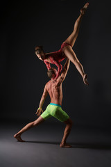 Duet of acrobats perform trick in studio