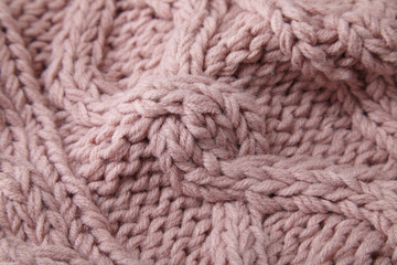 A full page close up of pastel pink knitted sweater fabric texture
