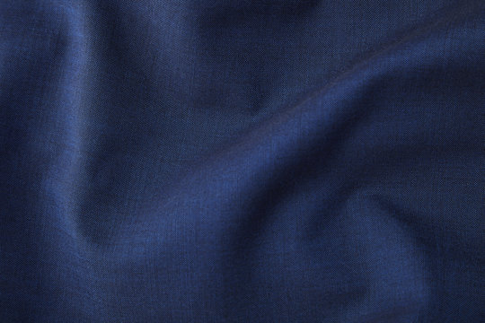A full page close up of rich blue suit material texture