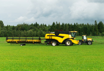 Agricultural machinery on the green field is ready for work.