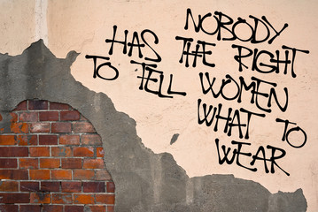 Nobody Has The Right To Tell Women What To Wear - Handwritten graffiti sprayed on the wall, anarchist aesthetics -freedom and emancipation of clothing. Fight against oppressive norms of obscenity