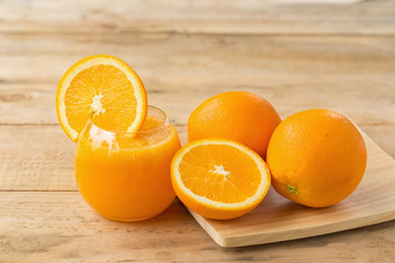 Orange juice and slices  on wooden table