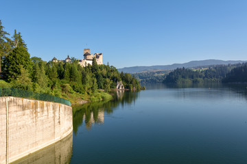Fototapeta na wymiar A view of medieval Dunajec castle from dam in Niedzica. Pieniny Mountains, Poland. Europe.