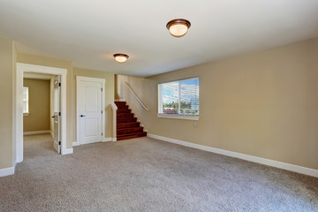 Spacious empty room in beige color with carpet