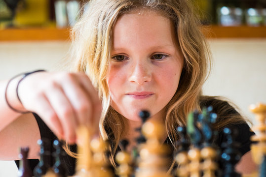 young girl playing chess