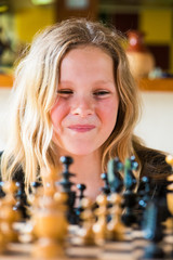 young girl playing chess