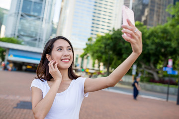 Woman taking selfie by mobile phone