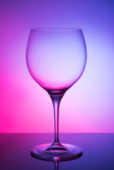 Glass glass of wine on a colored background