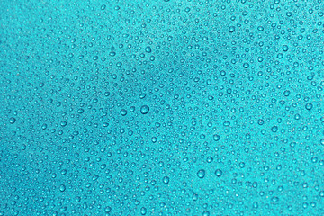 closeup drops water on blue background