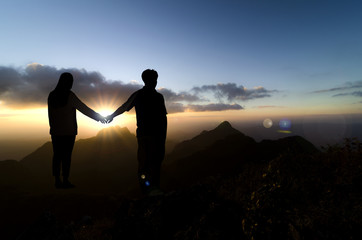 Fototapeta na wymiar Couple silhouette outdoors, beautiful sunset behind.