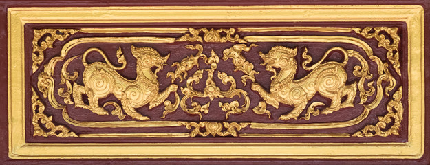 Thai traditional sculpture in Buddhist temple, Buntu Rajasri  the yellow lion in Himmapan world.