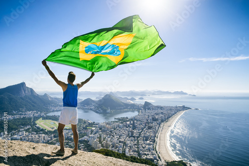 Athlete Stands Holding A Brazilian Flag At A Bright Overlook Of The City Skyline Of Rio De Janeiro Brazil Wall Mural Lazyllama