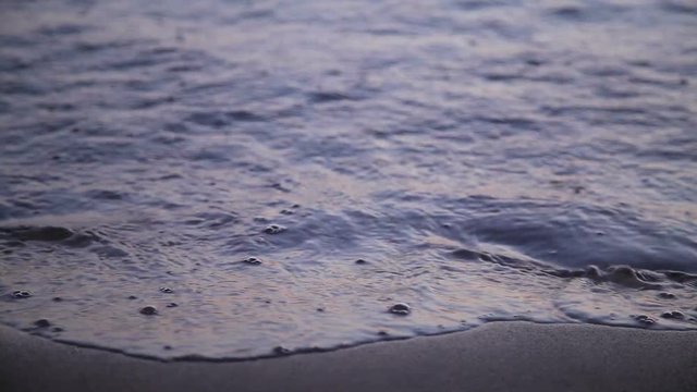 Heart drawn jn beach sand washed away by waves