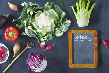 Restaurant menu template with vegetables and empty black board,