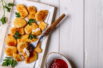Chicken nuggets with ketchup.