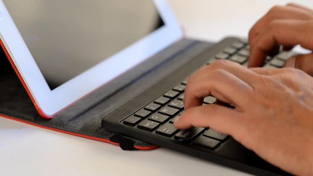 Close up office work on a tablet with keyboard