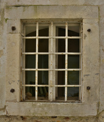 Fototapeta na wymiar A window in an old building in the historic Montenegrin town of Herceg Novi.
