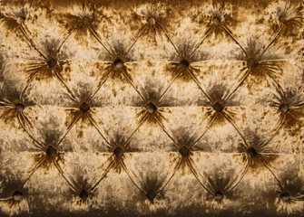 Golden capitone tufted velvet upholstery texture